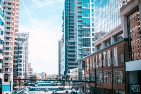 A view of Arlington VA, a city with colorful buildings and a busy street.